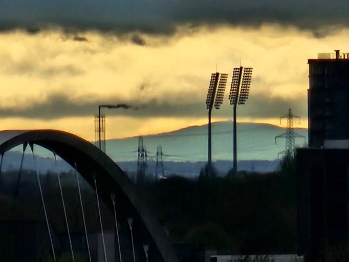 A distant hill behind some floodlights - it's Moel Famau over 50 miles away